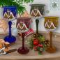 Preview: Christmas decoration windlight for Christmas goblet on long stand foot violet, blue, amber, green motif village church in winter series Lauscha Christmas