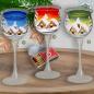 Preview: Christmas decoration windlight for Christmas on long stand foot motif winter village green, blue, or red, series Lauscha Christmas