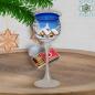 Preview: Christmas decoration windlight for Christmas on long stand foot motif winter village green, blue, or red, series Lauscha Christmas